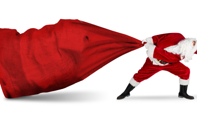 classic traditional crazy funny santa claus on exhausting delivery service. towing huge giant big red bag with christmas gift present  isolated  white background