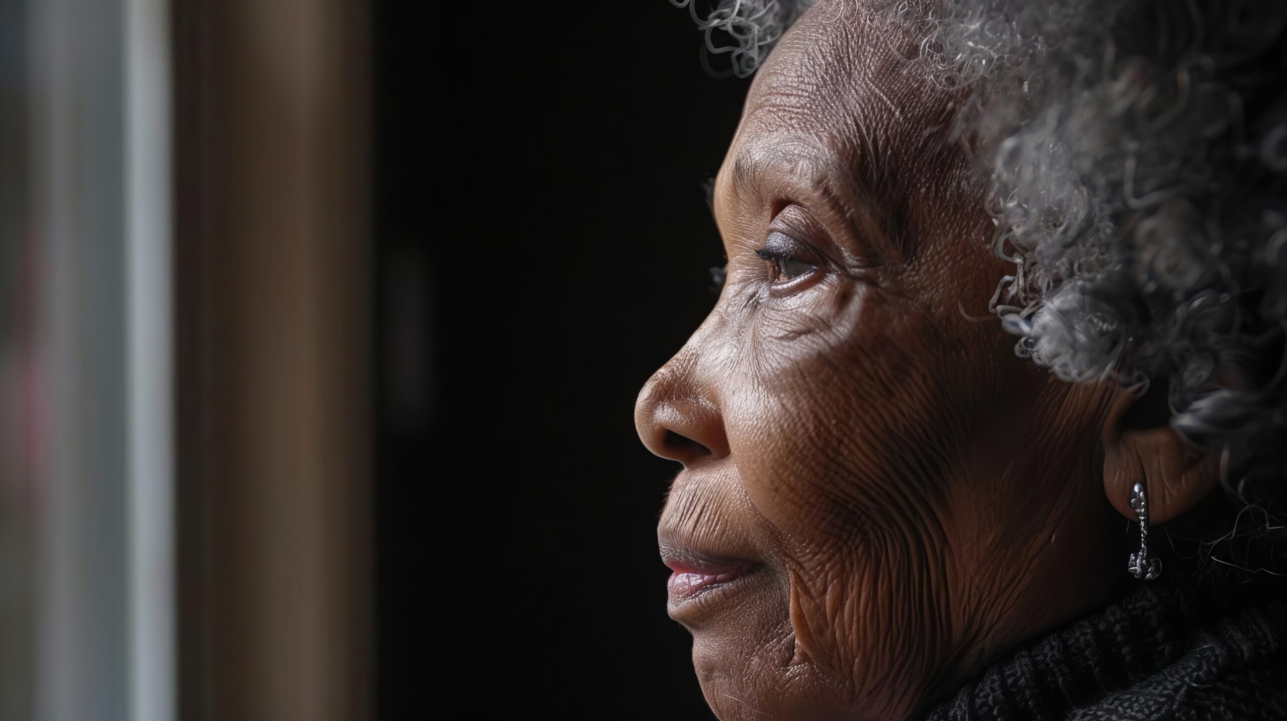 elderly black woman suffering from dementia closeup side profile degenerative disease concept